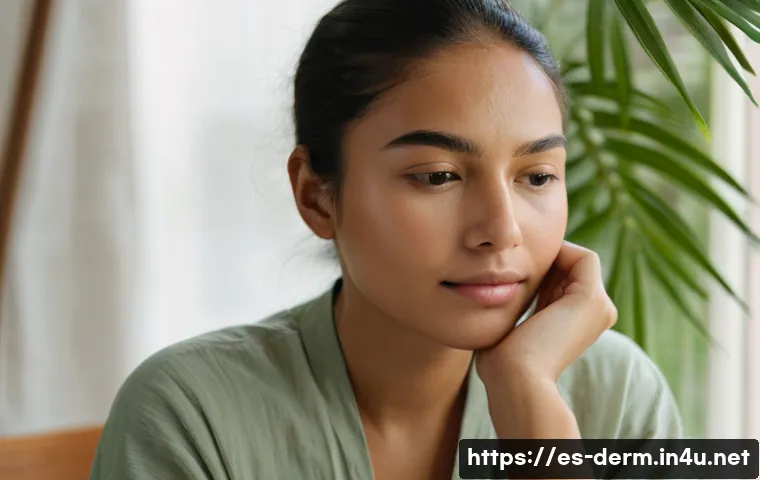 얼굴 홍조 완화 방법 - A serene young woman with light olive skin sitting calmly indoors, wearing a soft cotton blouse and ...